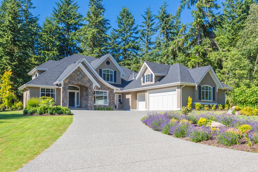 A beautiful home with a driveway and landscaping.