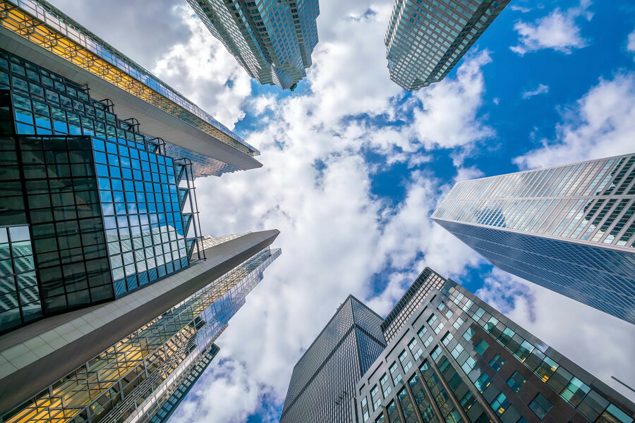 Looking up at skyscrapers in a city.