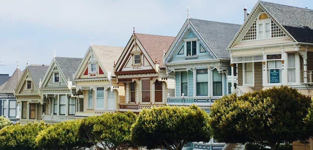 A row of painted Victorian houses in San Francisco, showcasing the exceptional real estate.