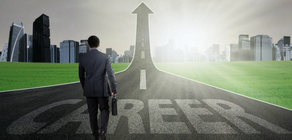 A businessman walking down a road with the word career in real estate on it.