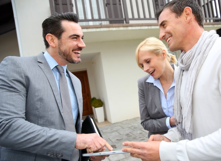 real estate agent showing house plan on-digital tablet