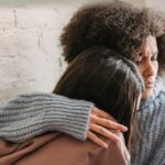 two-women-hugging-indoors-providing-emotional-support-and-comfort-in-a-cozy-setting