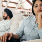 young-couple-experiencing-a-conflict-at-home-showcasing-emotional-distance-and-contemplation